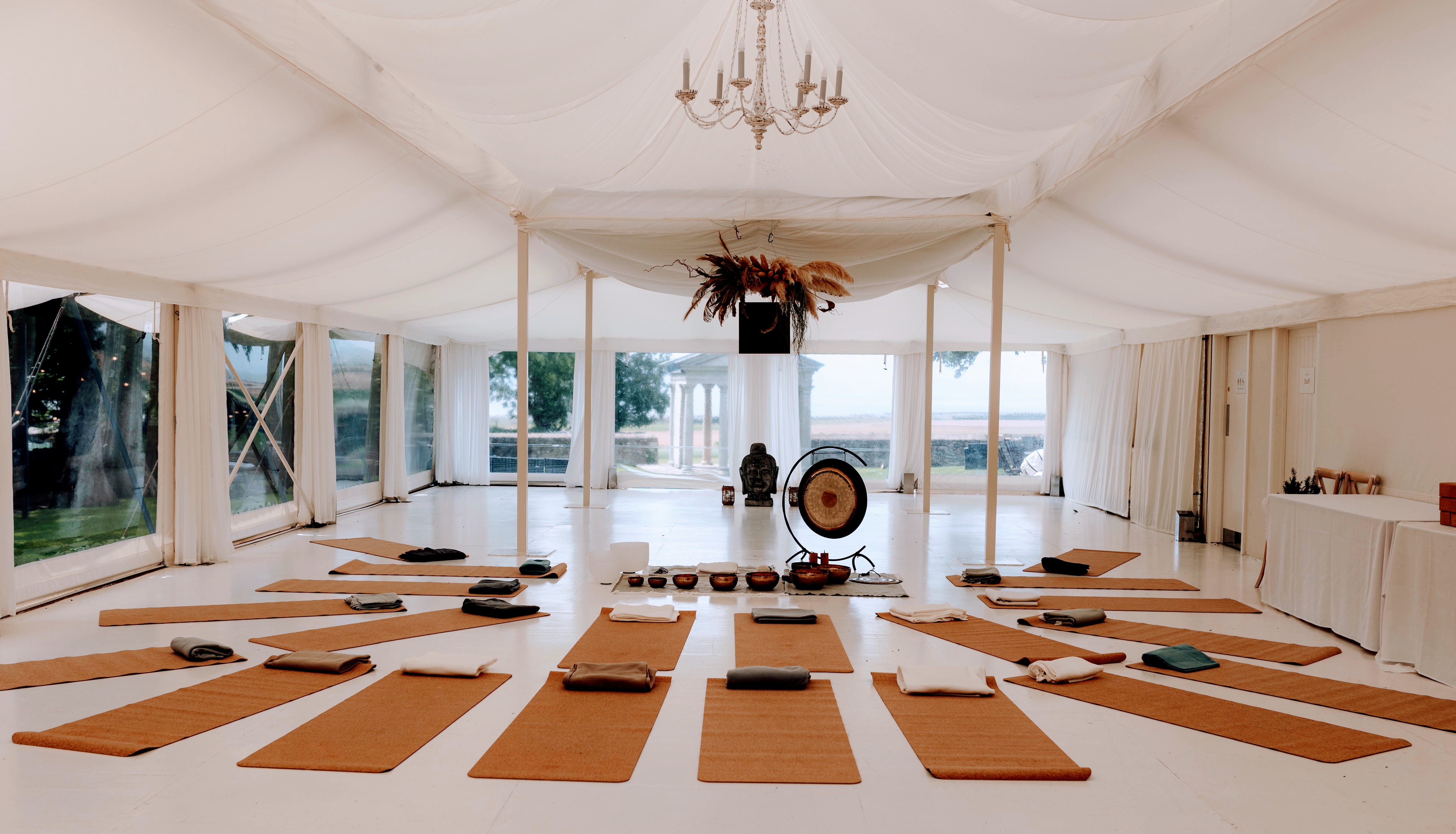 Cork mats laid out in a large event tent for a wellness session